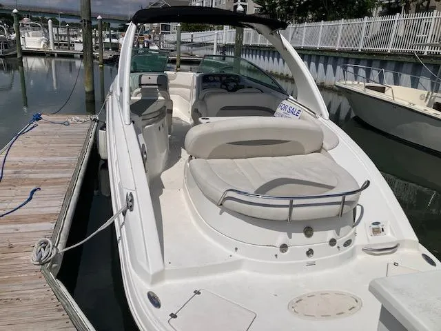 Slide: The Image of 2006 Chaparral 276 SSi boat docked, for sale sign visible. - 2