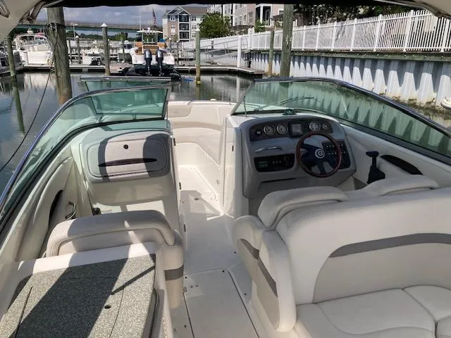 Slide: The Image of 2006 Chaparral 276 SSi boat interior at a marina, featuring seating and control console. - 8