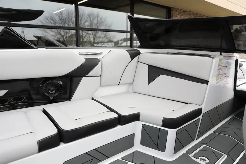Slide: The Image of Luxurious interior of 2026 Supreme S220 boat with sleek white and black seating. - 9