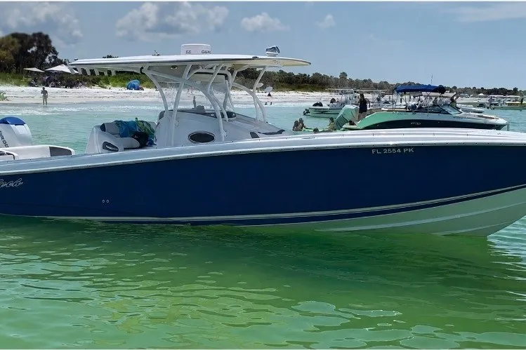 Slide: The Image of 2013 Nor-Tech 340 Sport boat on clear water near a sandy beach. - 5
