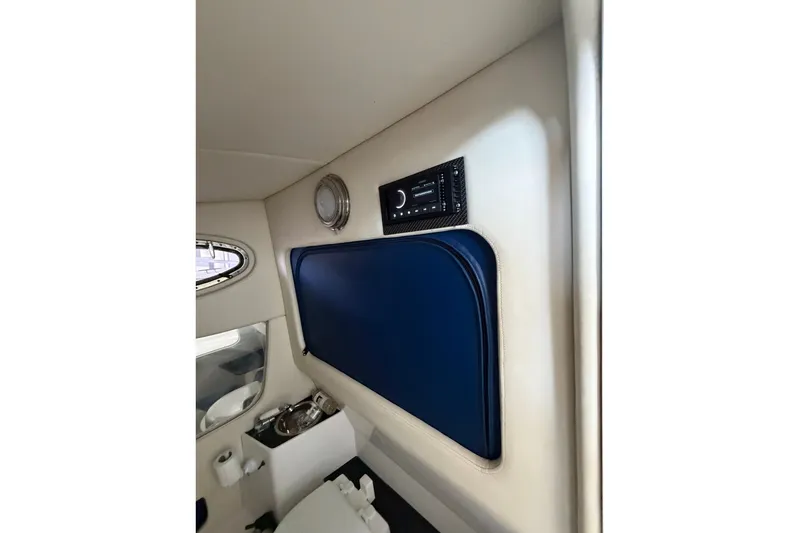 Slide: The Image of Interior cabin of 2013 Nor-Tech 340 Sport boat with blue accents and stereo system. - 25