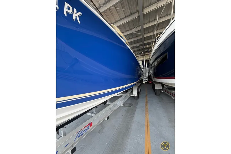 Slide: The Image of 2013 Nor-Tech 340 Sport boat in storage, blue hull, side view. - 6