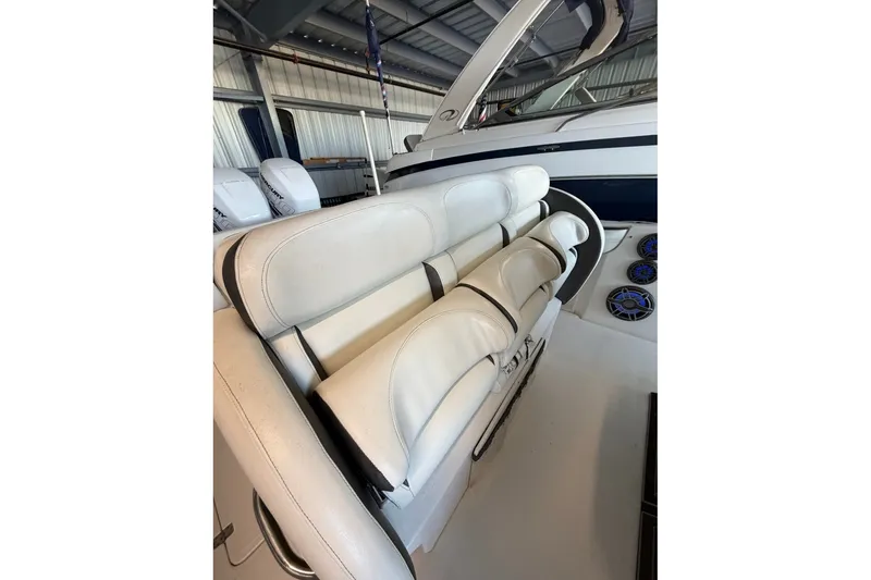 Slide: The Image of 2013 Nor-Tech 340 Sport boat interior with white seating and dashboard controls. - 20
