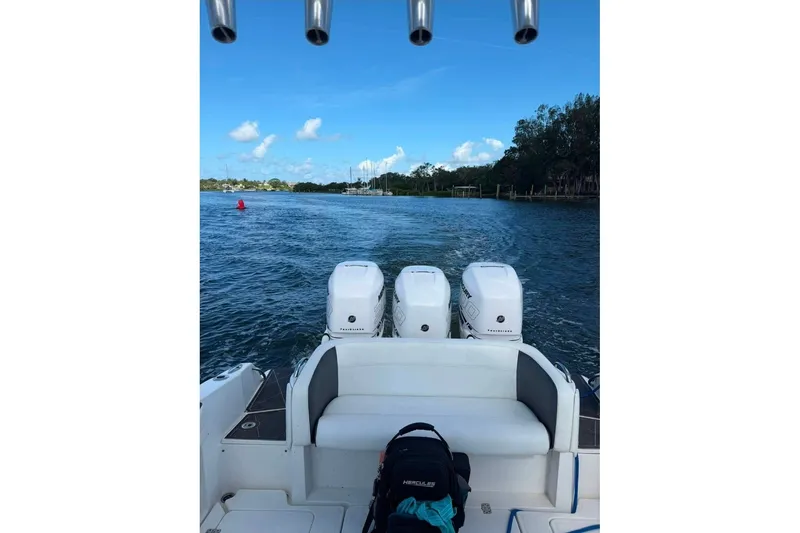 Slide: The Image of 2013 Nor-Tech 340 Sport boat with triple engines on a scenic waterway. - 10