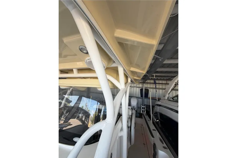 Slide: The Image of 2013 Nor-Tech 340 Sport boat interior with white framework and beige canopy. - 12