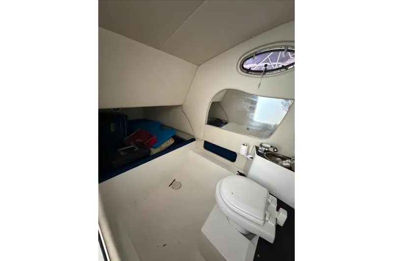 Slide: The Image of Interior cabin of 2013 Nor-Tech 340 Sport boat with toilet and storage area. - 18
