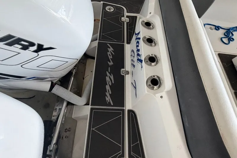 Slide: The Image of 2013 Nor-Tech 340 Sport boat deck with Mercury engine and rod holders. - 26