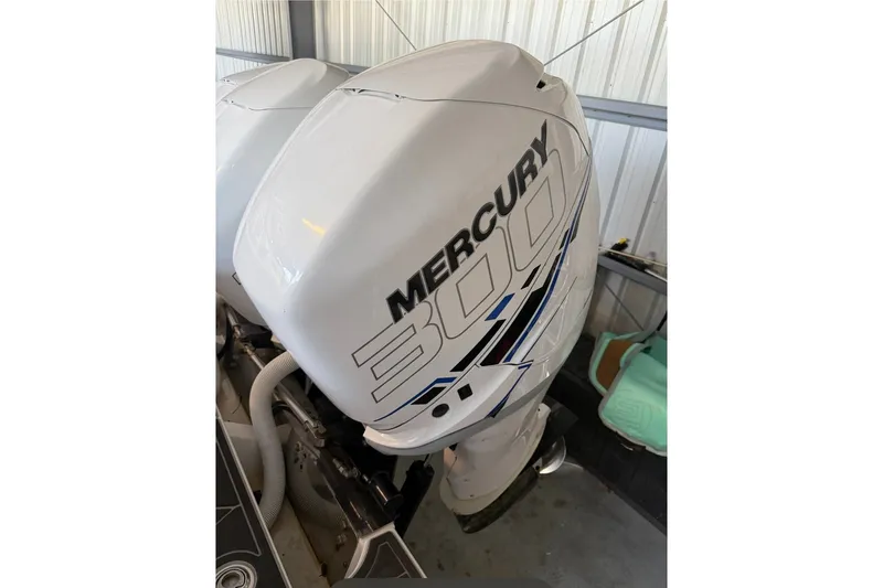Slide: The Image of 2013 Nor-Tech 340 Sport with Mercury 300 outboard engines in a storage facility. - 15