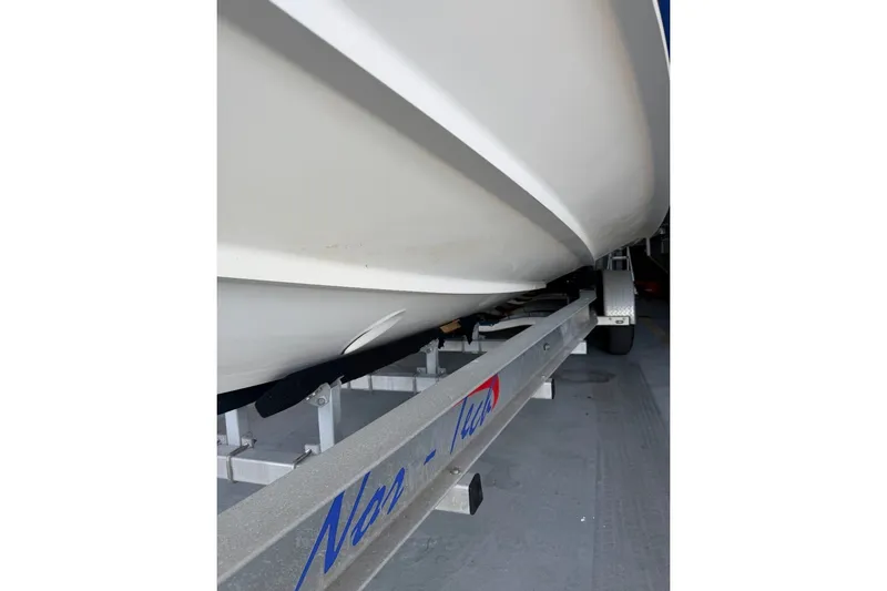 Slide: The Image of 2013 Nor-Tech 340 Sport boat on trailer, showcasing hull design. - 7