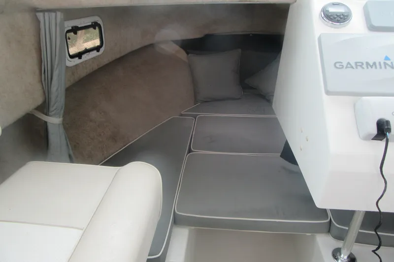 Slide: The Image of Interior cabin of a 2016 Parker 2120 Sport Cabin boat with cushioned seating. - 26