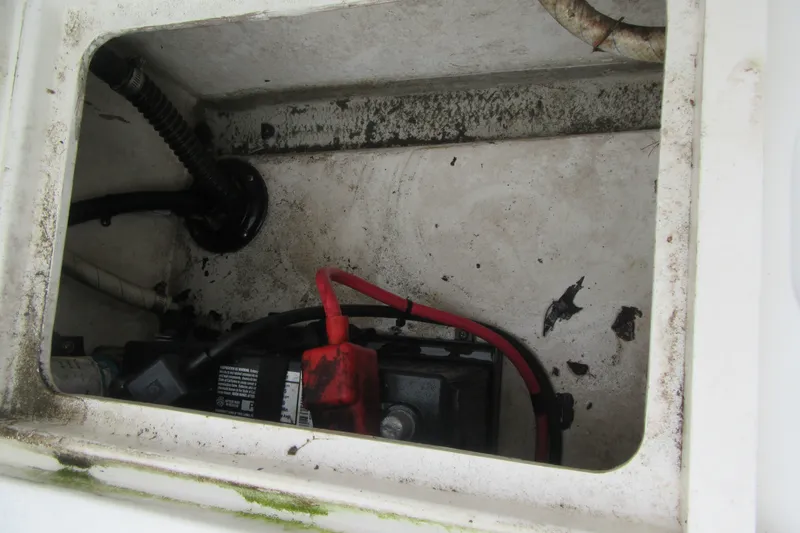 Slide: The Image of Battery compartment of a 2016 Parker 2120 Sport Cabin boat, showing cables and grime. - 16