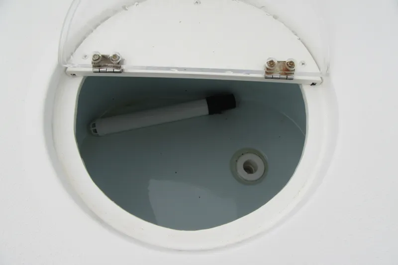 Slide: The Image of Open hatch on 2016 Parker 2120 Sport Cabin boat, revealing interior compartment. - 14