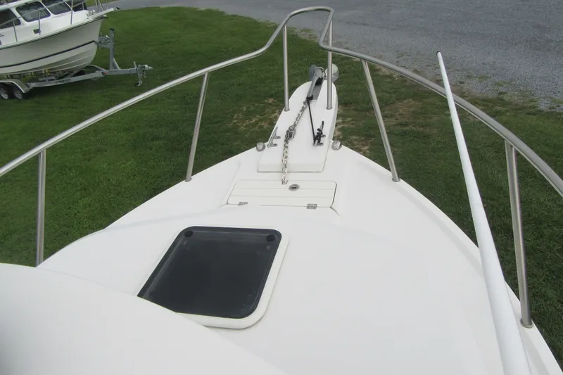 Slide: The Image of 2016 Parker 2120 Sport Cabin boat deck with railing and anchor chain. - 17
