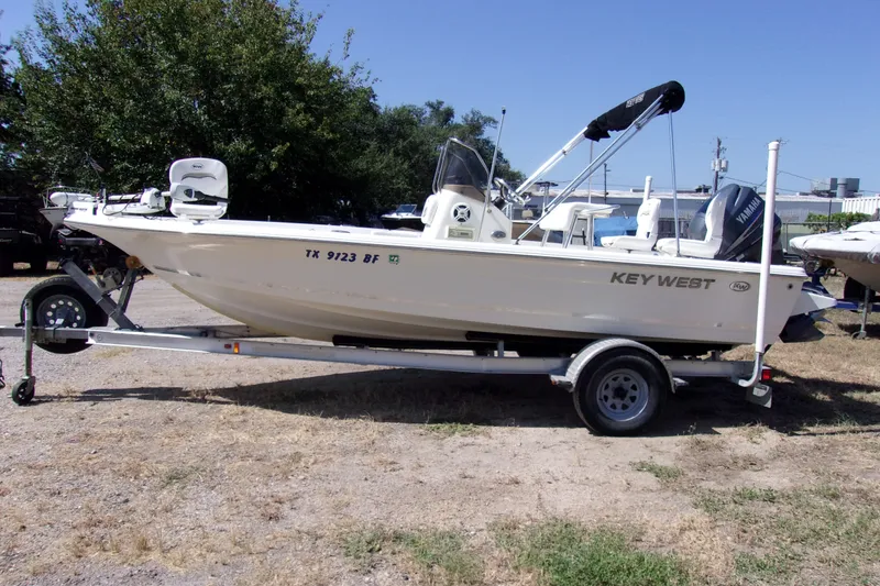 The Image of 2010 Key West 196 Bay Reef boat on trailer, parked outdoors. - 1