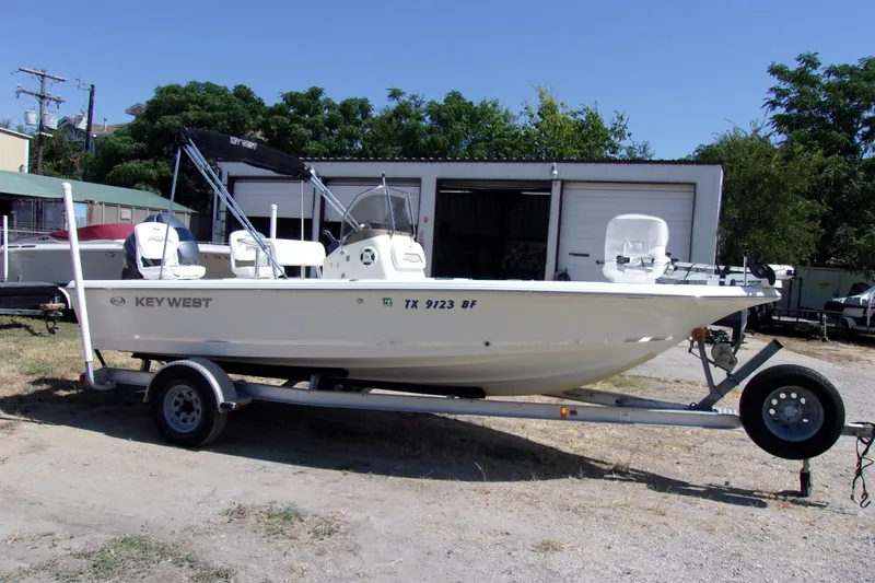 Slide: The Image of 2010 Key West 196 Bay Reef boat on trailer, parked outdoors. - 2