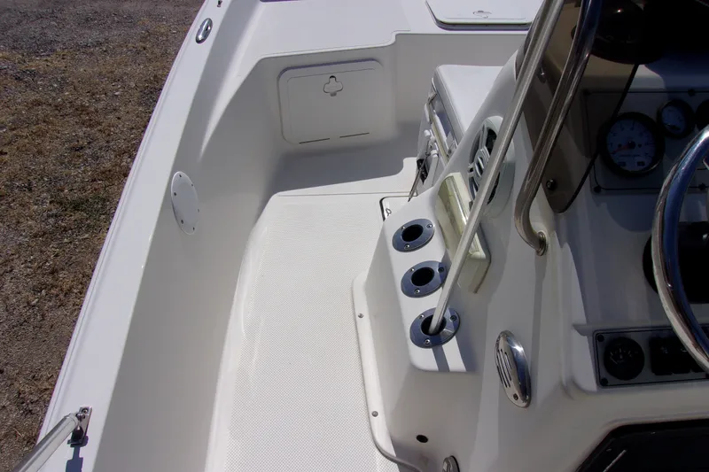 Slide: The Image of 2010 Key West 196 Bay Reef boat interior with steering console and rod holders. - 8