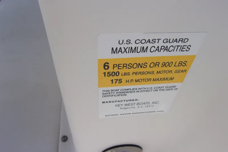 Slide: The Image of 2010 Key West 196 Bay Reef capacity label, 6 persons or 900 lbs, 175 HP motor. - 12