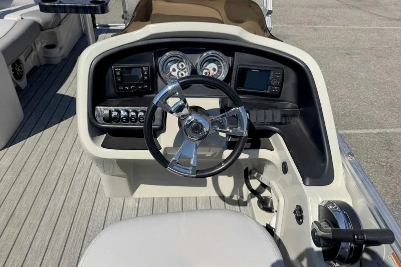 Slide: The Image of 2019 Avalon Catalina Rear Lounge 25' boat dashboard with steering wheel and controls. - 10