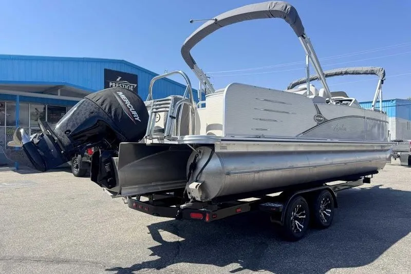Slide: The Image of 2019 Avalon Catalina Rear Lounge 25' pontoon boat on trailer, featuring Mercury outboard motor. - 5