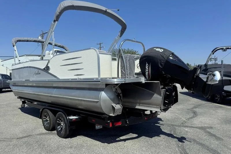 Slide: The Image of 2019 Avalon Catalina Rear Lounge 25' pontoon boat on trailer, featuring Mercury outboard motor. - 9