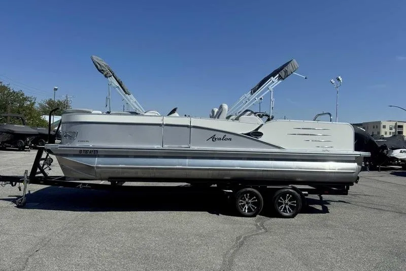 The Image of 2019 Avalon Catalina Rear Lounge 25' pontoon boat on trailer in parking lot. - 0