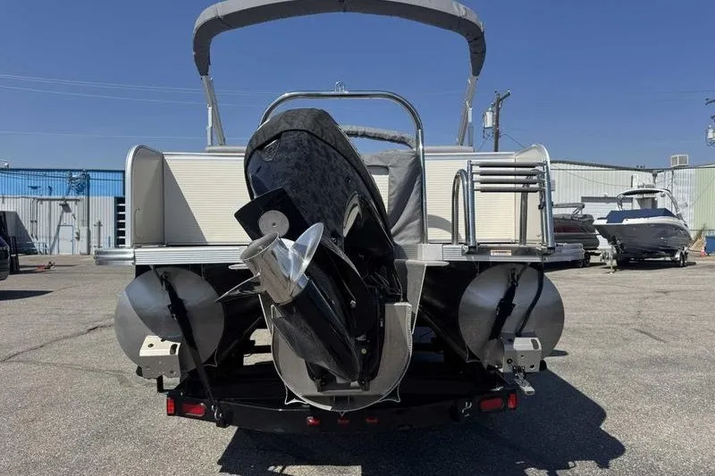 Slide: The Image of 2019 Avalon Catalina Rear Lounge 25' pontoon boat, rear view with motor and ladder. - 4