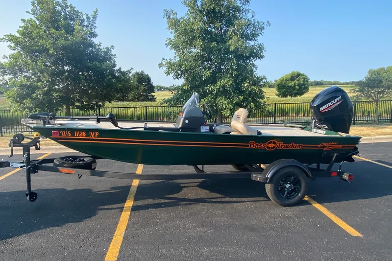 The Image of 2026 Tracker Bass Tracker Classic Limited boat on trailer in parking lot. - 1
