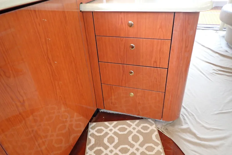 Slide: The Image of Wooden cabinetry with drawers inside a 1998 Sea Ray 480 Sedan Bridge yacht interior. - 116