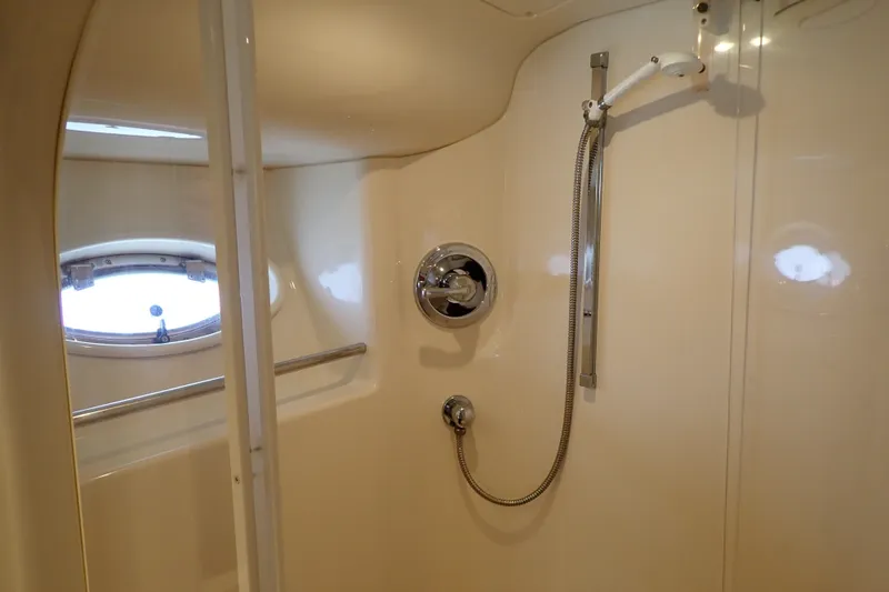 Slide: The Image of Shower area in 1998 Sea Ray 480 Sedan Bridge yacht with porthole window. - 36