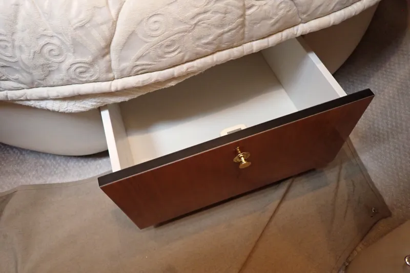Slide: The Image of Open drawer under bed in 1998 Sea Ray 480 Sedan Bridge yacht interior. - 144