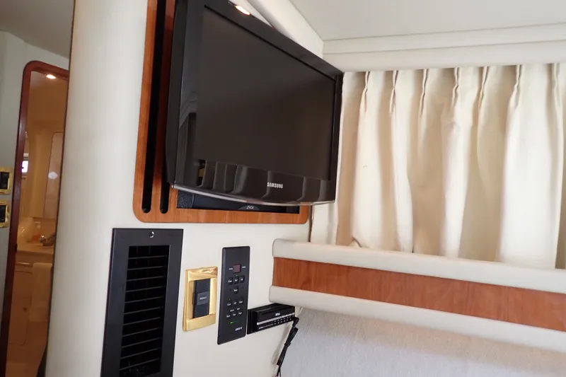 Slide: The Image of Interior of 1998 Sea Ray 480 Sedan Bridge with mounted TV and control panel. - 41