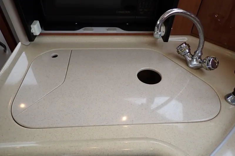 Slide: The Image of Kitchen sink area on a 1998 Sea Ray 480 Sedan Bridge yacht. - 103