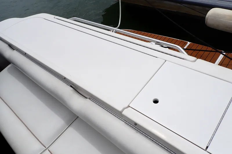 Slide: The Image of 1998 Sea Ray 480 Sedan Bridge swim platform with white surface and railing. - 79
