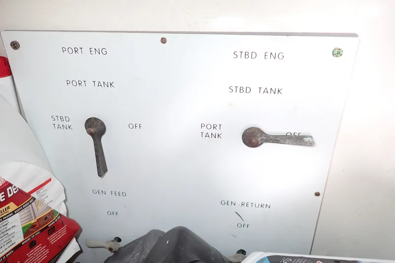 Slide: The Image of Control panel of a 1998 Sea Ray 480 Sedan Bridge boat, showing engine and tank switches. - 74