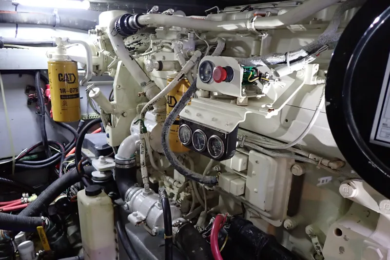 Slide: The Image of Engine room of 1998 Sea Ray 480 Sedan Bridge with CAT components and gauges. - 194
