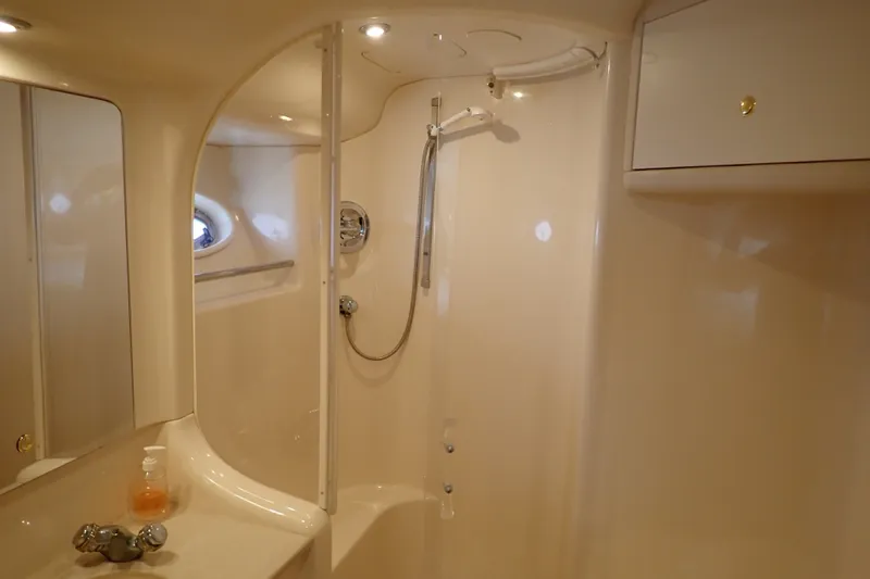 Slide: The Image of Bathroom interior of 1998 Sea Ray 480 Sedan Bridge yacht, featuring shower and sink. - 189
