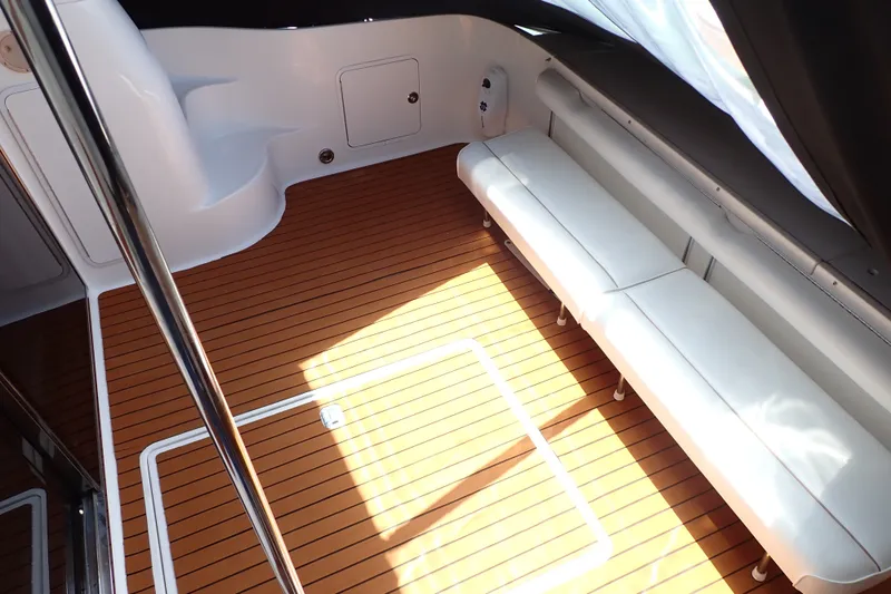 Slide: The Image of 1998 Sea Ray 480 Sedan Bridge interior with teak flooring and white seating. - 11