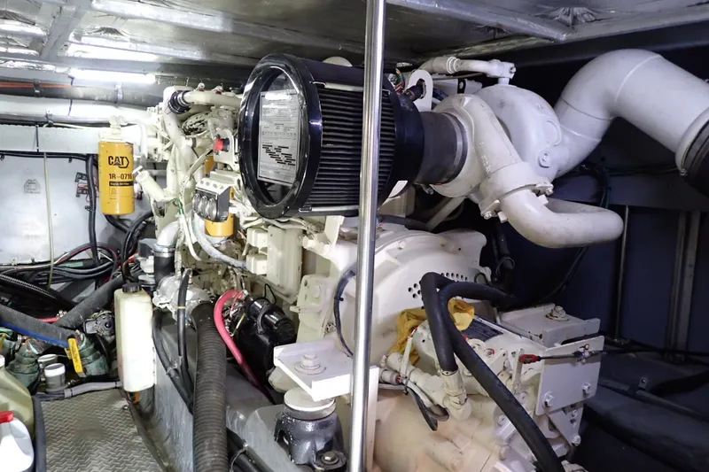 Slide: The Image of Engine room of 1998 Sea Ray 480 Sedan Bridge with visible CAT components. - 192