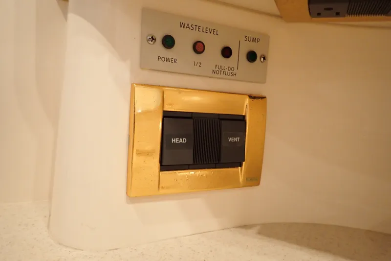 Slide: The Image of Control panel on 1998 Sea Ray 480 Sedan Bridge yacht, featuring waste level and sump indicators. - 186