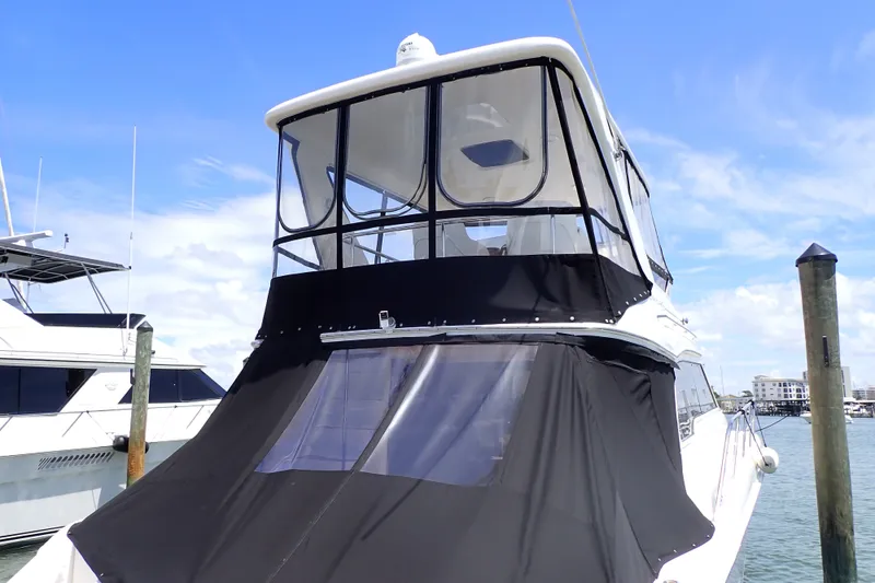Slide: The Image of 1998 Sea Ray 480 Sedan Bridge yacht docked under clear blue sky. - 2