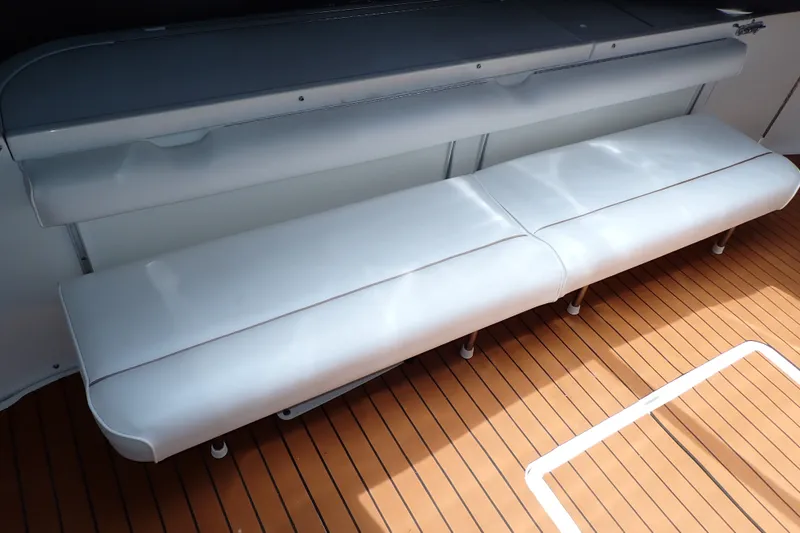 Slide: The Image of White seating on 1998 Sea Ray 480 Sedan Bridge yacht with teak flooring. - 67