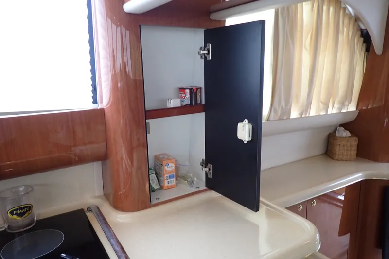 Slide: The Image of Interior of 1998 Sea Ray 480 Sedan Bridge yacht kitchen with open cabinet. - 119