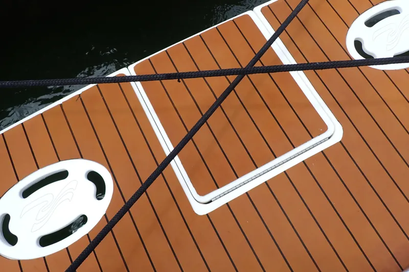 Slide: The Image of Deck of 1998 Sea Ray 480 Sedan Bridge with ropes and hatch. - 89