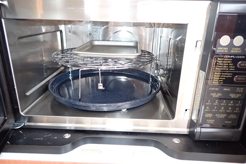 Slide: The Image of Microwave oven interior with metal rack and tray, featuring control panel on the right. - 102