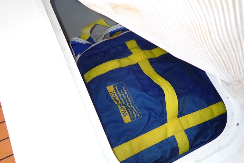 Slide: The Image of Blue and yellow life jacket stored on a 1998 Sea Ray 480 Sedan Bridge. - 62