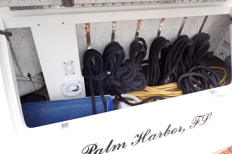 Slide: The Image of Storage compartment on 1998 Sea Ray 480 Sedan Bridge with coiled ropes and cables. - 86