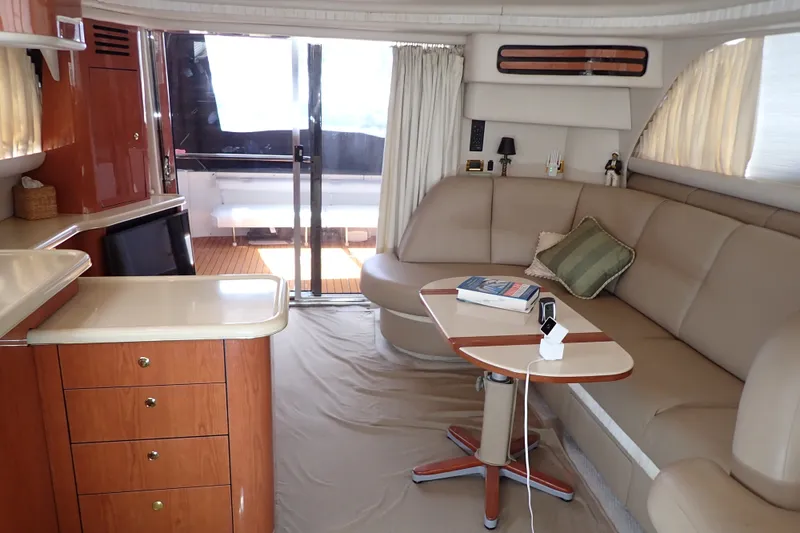 Slide: The Image of Luxurious interior of 1998 Sea Ray 480 Sedan Bridge yacht with elegant seating and table. - 15