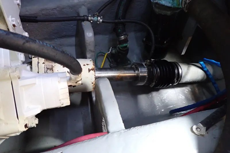 Slide: The Image of Engine compartment of a 1998 Sea Ray 480 Sedan Bridge, showing mechanical components and hoses. - 195