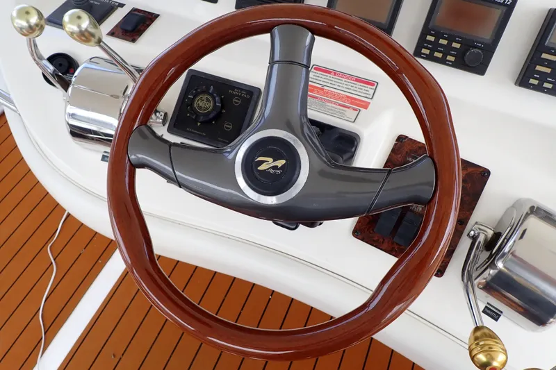 Slide: The Image of Steering wheel and controls of a 1998 Sea Ray 480 Sedan Bridge yacht. - 54