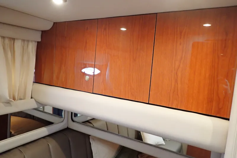 Slide: The Image of Interior of 1998 Sea Ray 480 Sedan Bridge with polished wood cabinets and beige upholstery. - 146